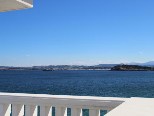 a view of a large body of water from a balcony at Hotel Chiqui in Santander