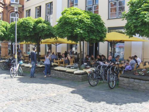 a group of people sitting at tables outside a building at Hotel Frøslev Kro in Padborg