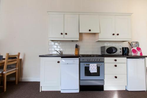 a kitchen with white cabinets and an oven at Dublin Vacation Rentals in Dublin