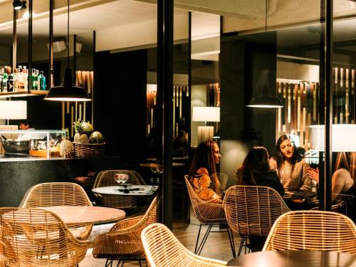 a group of women sitting in a restaurant at Hotel Chiqui in Santander