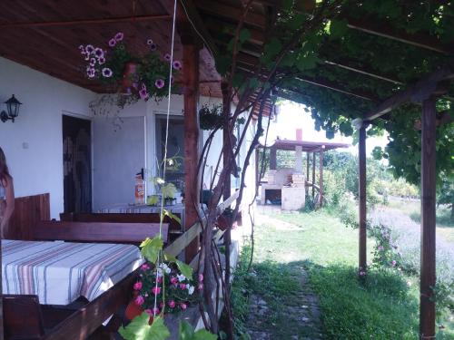 a bedroom with a bed and a tree at Gledkata Complex in Skobelevo