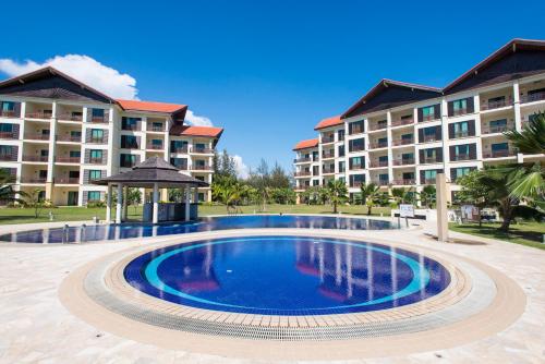 a swimming pool in front of a hotel at Sabah Beach Villas & Suites in Kota Kinabalu