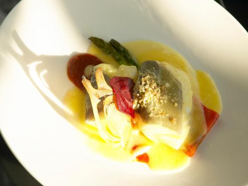 a white plate of food with a spoon at Hotel Chiqui in Santander
