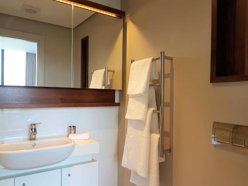 a bathroom with a sink and a mirror at Zimbali Suites 507 in Ballito