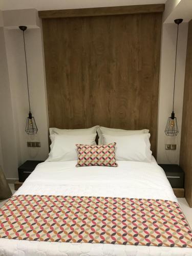 a bedroom with a large white bed with two pillows at B. U. Luxury Apartments in Asprovalta