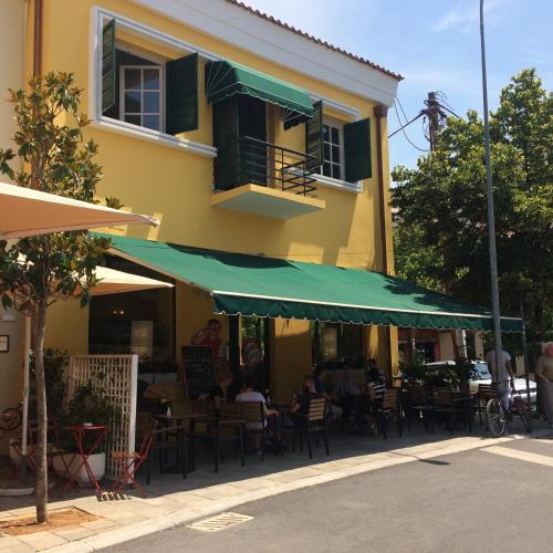 a restaurant with tables and chairs in front of a building at Stephen Center B&B in Tirana