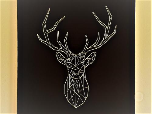 a geometric deer head with antlers on a black background at Ferienwohnungen Haus Marlene Kaiser in Bernau im Schwarzwald