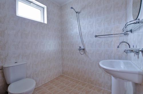 a bathroom with a toilet and a sink at Iskar Villas in Kranevo