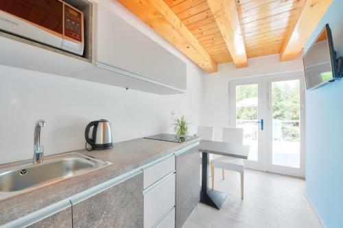a kitchen with a sink and a counter top at Villa Oliver 3 Siófok in Siófok