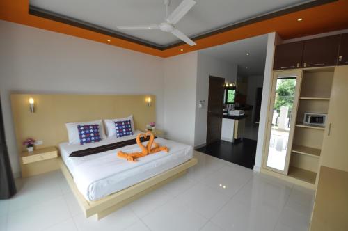 a bedroom with a bed with an orange toy on it at Duangjai Residence in Rawai Beach