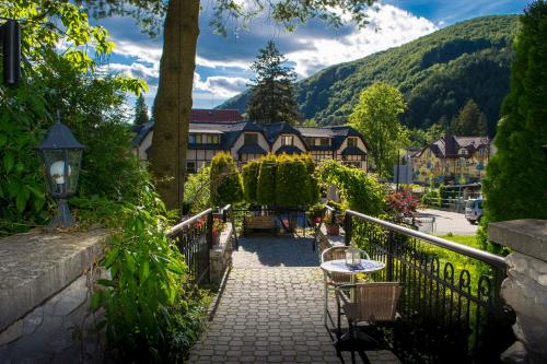a walkway with a table and chairs in a village at Penzión Talisman in Rajecké Teplice