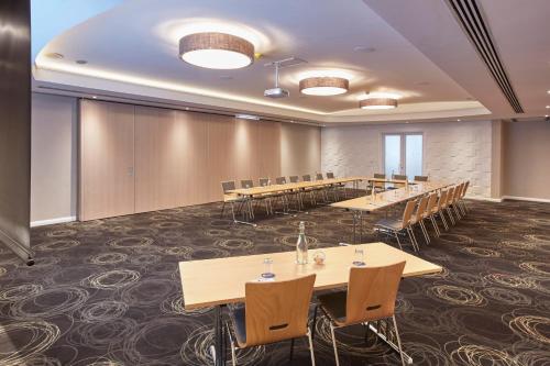 a large conference room with tables and chairs at President Hotel in Cape Town