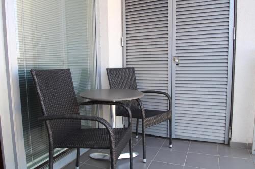 a small table and chairs on a balcony at Apartman Halex Centrum City aupark in Piešťany