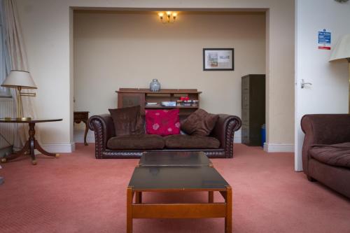a living room with a couch and a table at Stanley House in Eskdale