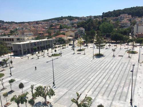 a large plaza with trees and lights in a city at Aenos Hotel in Argostoli