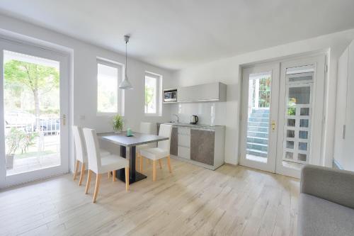 a kitchen and dining room with a table and chairs at Villa Oliver 3 Siófok in Siófok
