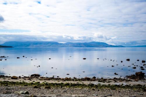 a large body of water with mountains in the background at Lexington Apartments in Rothesay
