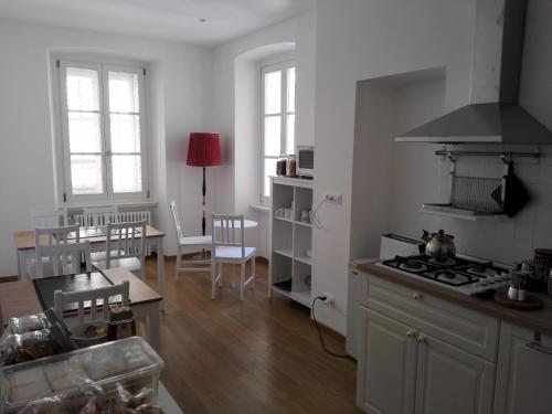 a kitchen with a stove top oven next to a table at Palazzo Brigido in Trieste