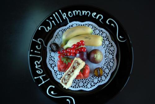 a plate of fruit on a black and white plate at Morosani Schweizerhof in Davos