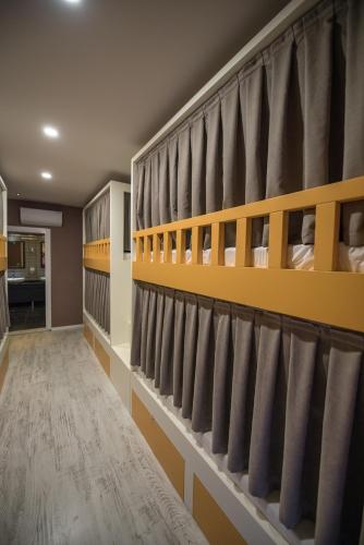 a locker room with grey and yellow shelving at Sakura Hostel Fethiye in Fethiye