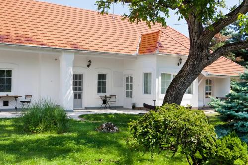a white house with an orange roof at Öreg Malom Apartmanház in Bogács