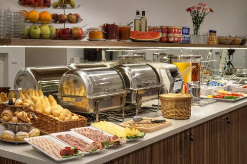 a kitchen counter filled with lots of different types of food at Hotel Taurus in Prague