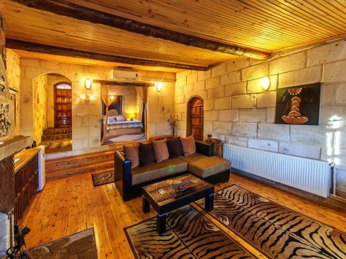 a living room with a couch and a fireplace at Adanos Konuk Evi in Avanos