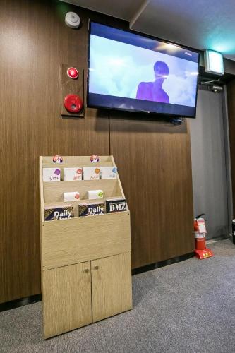 a flat screen tv on a wall in an office at Philstay Myeongdong Station in Seoul