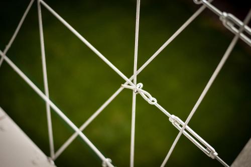 a close up of a metal fence with a green background at Villa Oliver 3 Siófok in Siófok