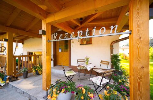 a patio with a sign for a restaurant at Lehenriedl Chalet in Wagrain