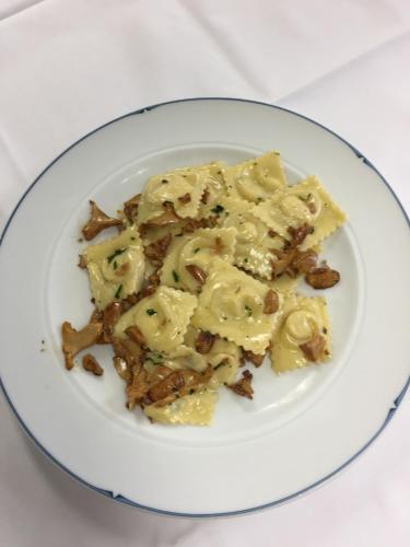 a plate of food with pasta on a table at Hotel & Restaurant Forni in Airolo