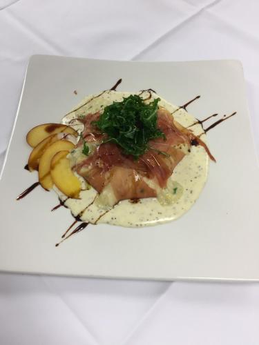 a plate of food on a white plate with bananas at Hotel & Restaurant Forni in Airolo