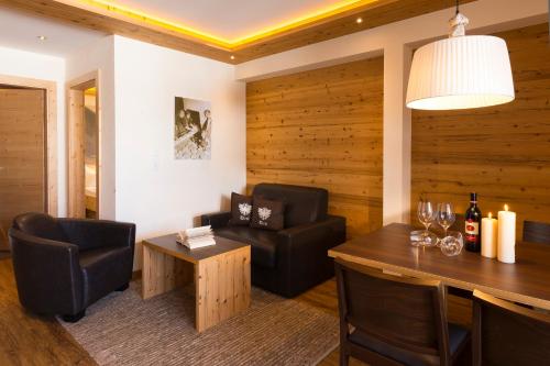 a living room with a table and chairs and a dining room at Romantica Schlössl in Fiss