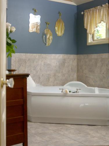 a bath tub in a bathroom with blue walls at Heartstone Inn in Eureka Springs