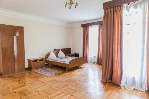 a bedroom with a bed and a large window at Резиденция Президента в Мюссере in Miusera