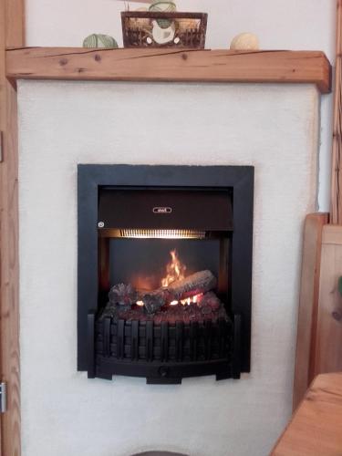 a fireplace with a fire inside of it at Schlosserhof in Telfes im Stubai
