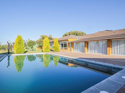 a house with a swimming pool in front of a house at El Toril Glamping Experience in Parrillas