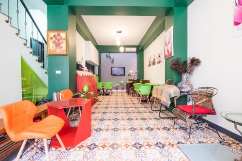 a restaurant with colorful chairs and tables in a room at Zhizhu Homestay in Tainan