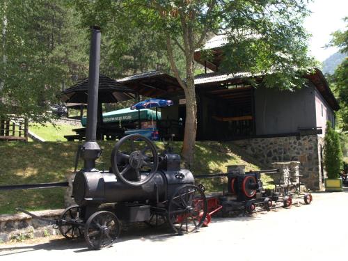 a small train on display in front of a building at Apartment Bajka in Mokra Gora