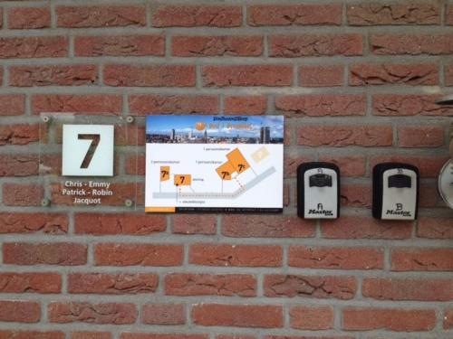 
a brick wall with several different types of signs on it at Eindhoven 2 Sleep in Eindhoven
