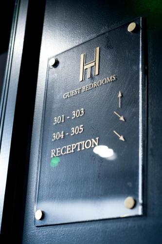 a sign for a guest refridgerator with the price of the room at The House of Toby in London