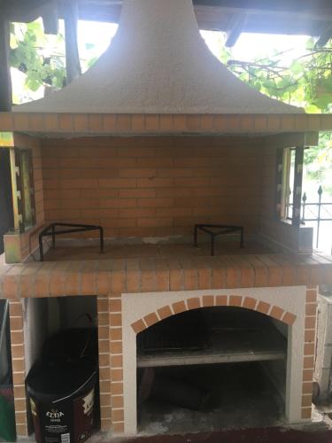 an outdoor brick oven with a trash can in it at Estia Studios in Stavros