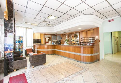 a lobby with a bar in a building at Hotel Aldebaran in Rimini