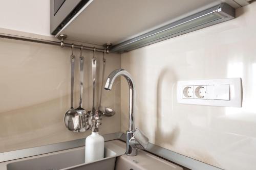 a kitchen with a sink and a faucet at Lux Apartments Petar in Baška Voda