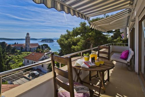 a balcony with a table and chairs and a view of the ocean at Castle Štambuk in Hvar