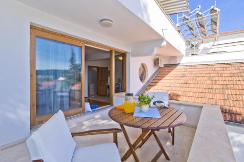 a patio with a table and chairs on a balcony at Castle Štambuk in Hvar