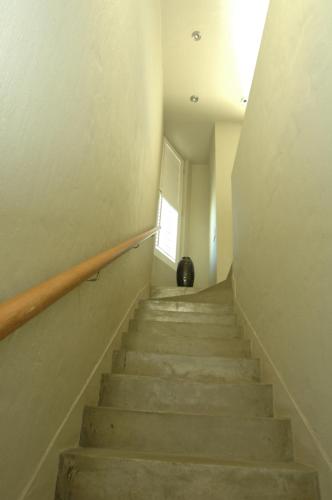 a staircase in an empty room with a window at Mosselberg on Grotto Beach in Hermanus
