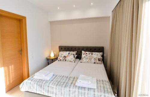 a bedroom with a bed with two towels on it at Island Dreams Rooms & Suites in Rhodes Town
