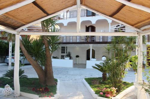 a large building with a palm tree in the middle at Villa Miriam in Gragnano