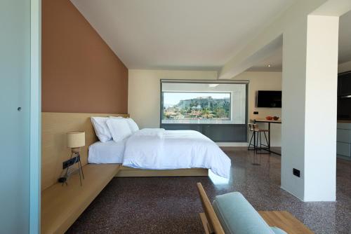 a bedroom with a large bed with a large window at Acropolis View Luxury Apartment in Athens